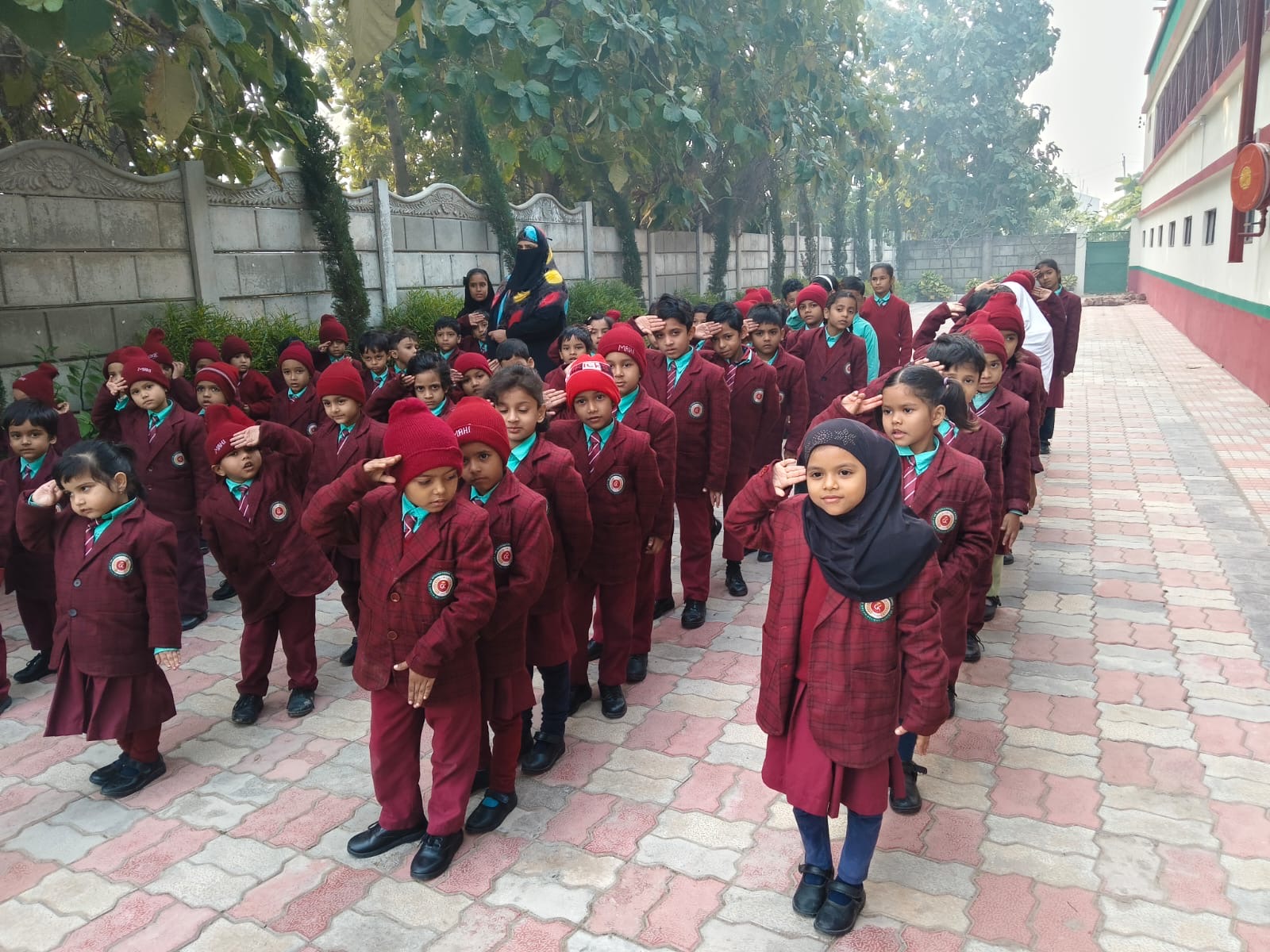 GK International School students in morning assembly salute